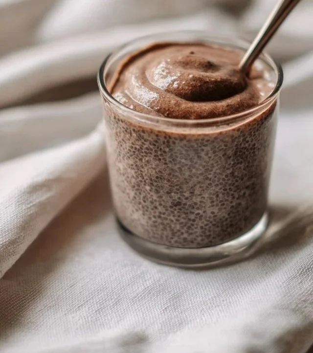 A bowl of creamy chia seed pudding suitable for babies, topped with fresh fruit.