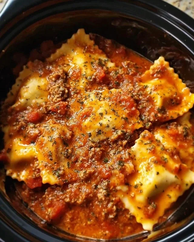 Delicious Crockpot Ravioli Lasagna layered with cheese and marinara sauce.
