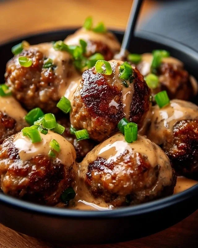 Plate of Korean BBQ Meatballs served with spicy mayo dip for a flavorful appetizer.