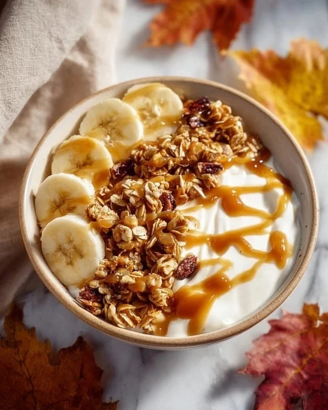 Delicious salted caramel banana yogurt bowl topped with fresh banana slices