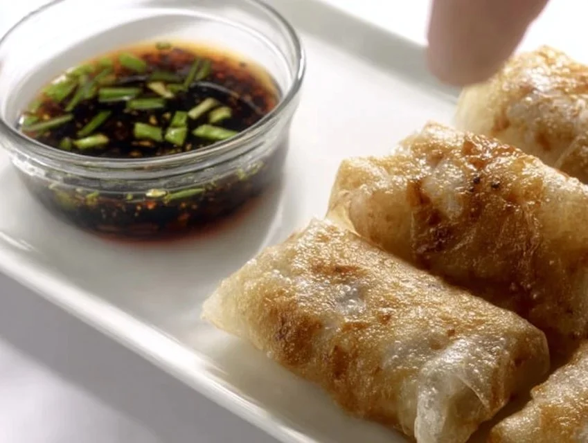 Plate of delicious Rice Paper Dumplings filled with vegetables and herbs.