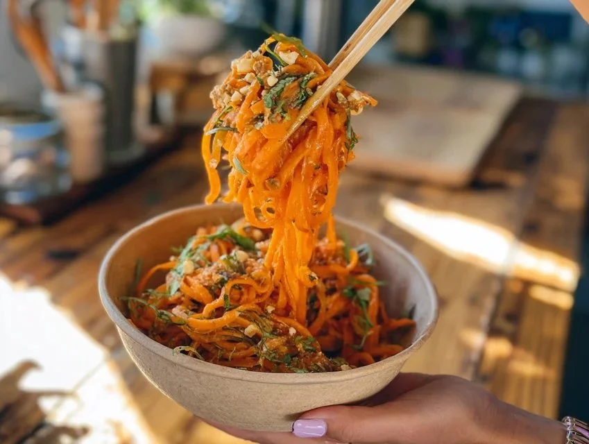 Viral carrot salad served in a bowl with fresh veggies and dressing